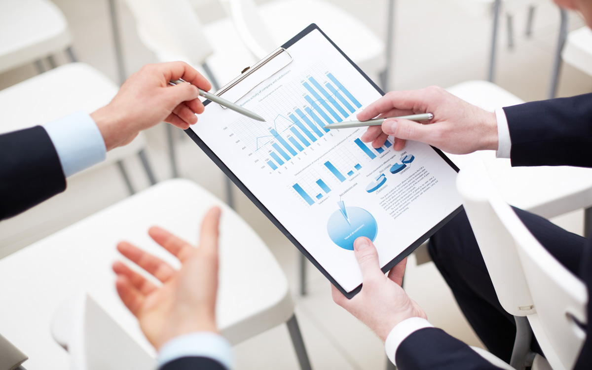 Business analytics and automation consultation showing professionals analyzing charts and data